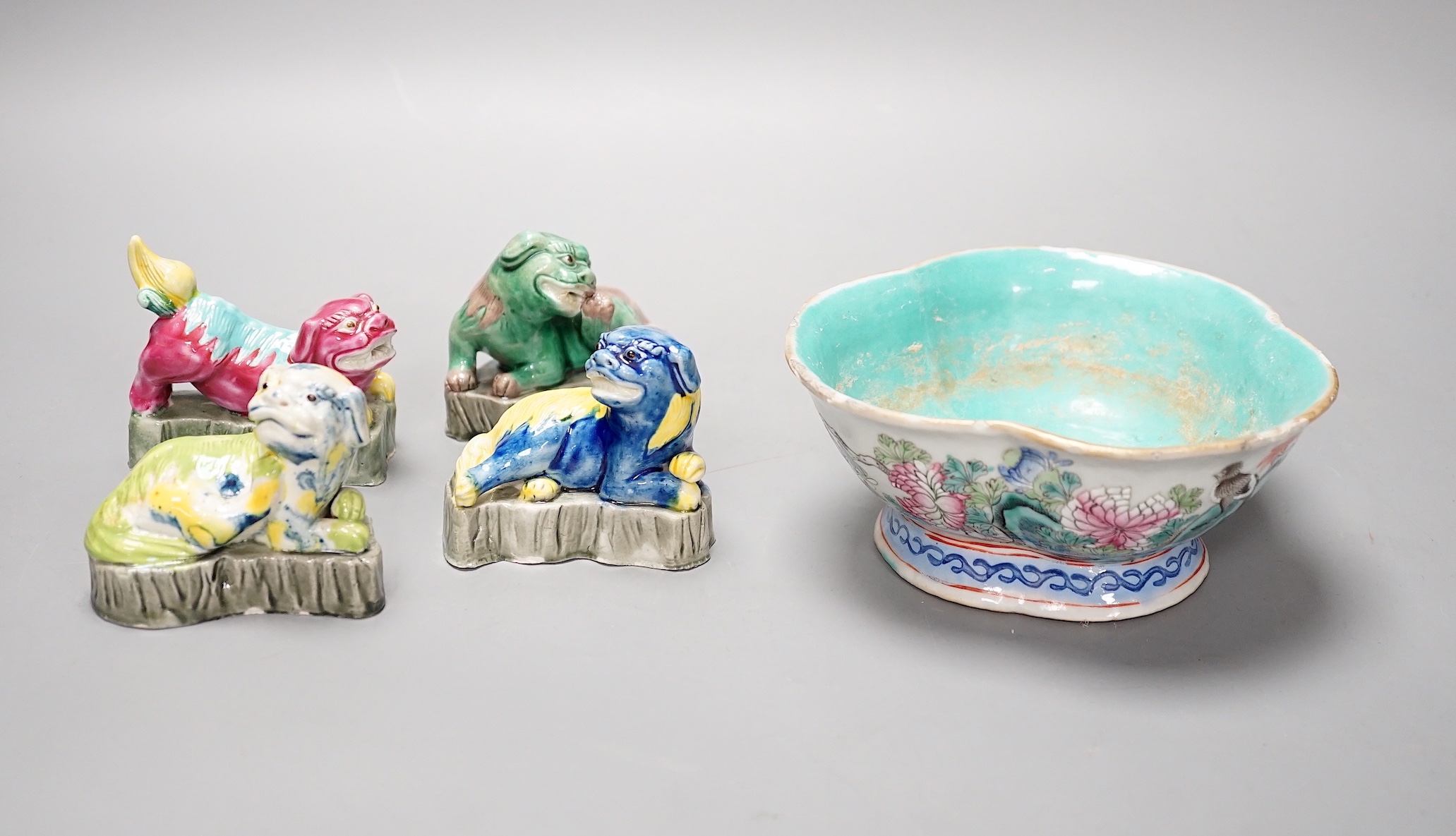 Four Chinese polychrome glazed models of lion-dogs, Republic period and a Chinese famille rose dish, Tongzhi mark, 15.5cm (5)